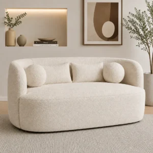 Luxury cream performance fabric 2-seater sofa featuring a sculptural curved silhouette and soft bouclé upholstery for modern homes.