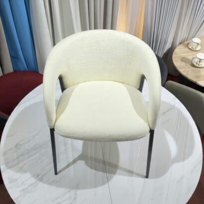 The Ansary contemporary chair in a dining room setting with drapes.