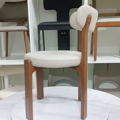 Sculptural dining chair with curved backrest.