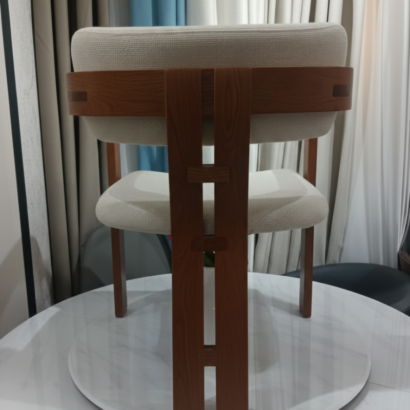 3. Minimalist solid wood dining chair with curved backrest.