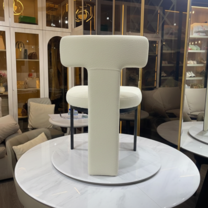 Contemporary T-back chair on marble table display front angle.