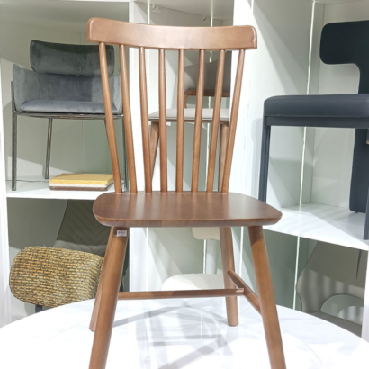 Mid-century modern wooden chair with tapered legs.