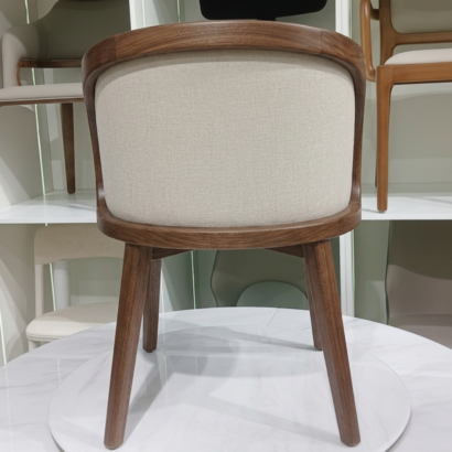 Luxury curved dining chair with wrap-around backrest.