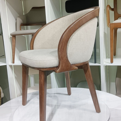 Modern walnut wood accent chair with linen upholstery.