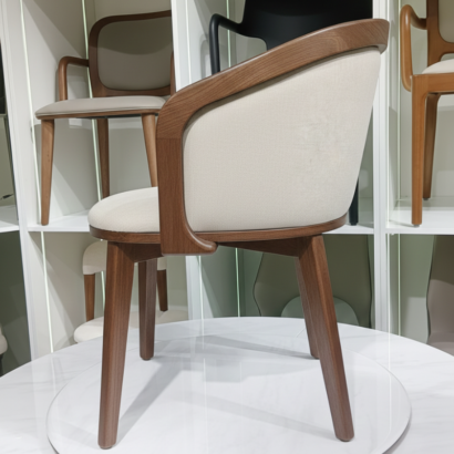 Ergonomic barrel-style dining chair by Ansary Furniture.