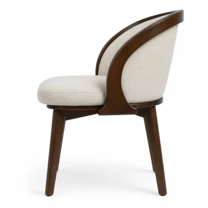 Side view of Serene barrel dining chair with curved upholstered back and wooden legs