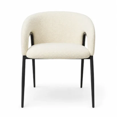 Cream bouclé dining chair with curved upholstered back and black metal legs