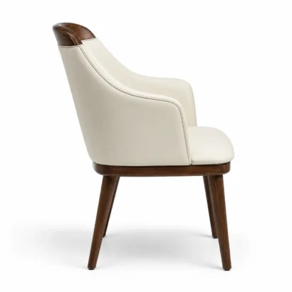 Side view of cream faux leather dining chair showing curved back and wooden legs