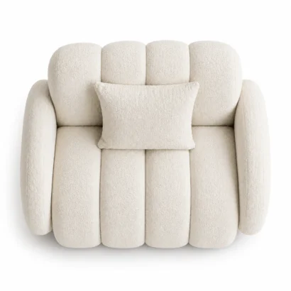 White bouclé club chair with plush upholstery and matching cushion