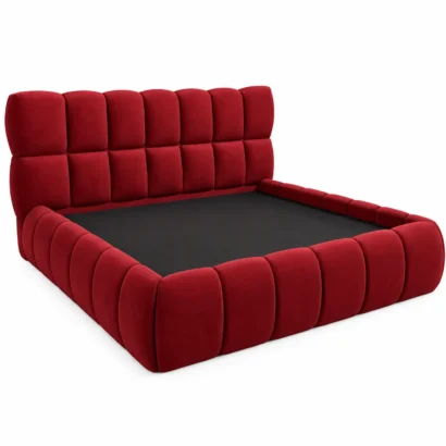 Burgundy velvet upholstered bed styled in a modern bedroom with gold accents