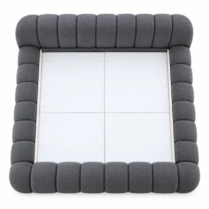 Overhead view of a charcoal upholstered bed frame with segmented padded borders.