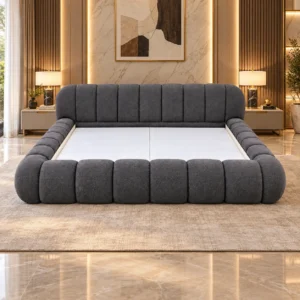 Charcoal upholstered bed frame styled in a warm contemporary bedroom.