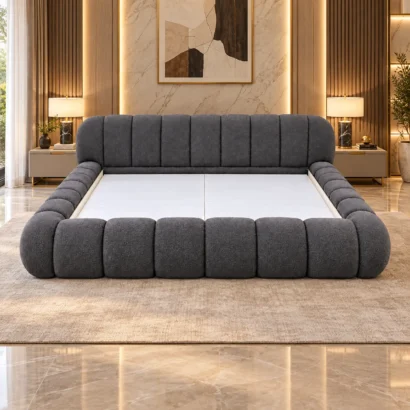 Charcoal upholstered bed frame styled in a warm contemporary bedroom.