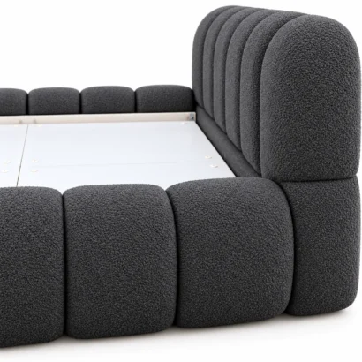Luxury charcoal bouclé bed frame showing textured upholstery and padded detailing.